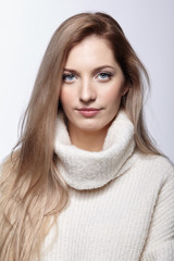 Naklejka premium Blonde woman in woolen sweater