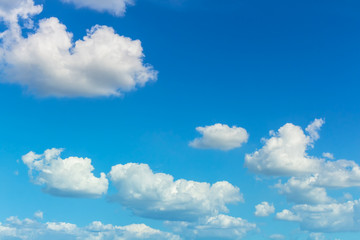 Obraz na płótnie Canvas bright clouds floating on color blue sky with wind