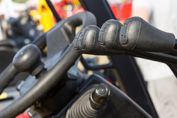 Operating control panels or levers and steering wheel in forklift