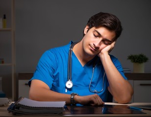 Young handsome doctor working night shift in hospital
