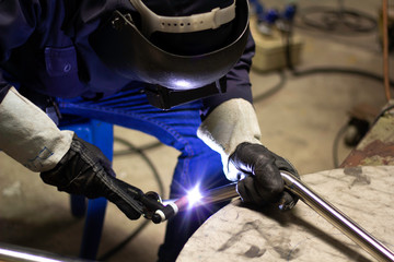 Metal workers use manual labor. Skilled welder. Factory workers making OT. Welder is welding the...