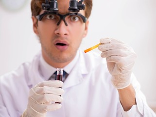 Chemist in the lab checking with ph strips