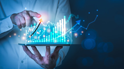 Businessman using tablet and technology. Digital marketing of Sales and Economic growth graph chart.