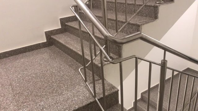 An Chrome plated Stainless steel hand rail for an fire staircase which interior finishes done by granite for steps tread riser and midland slab for an highrise buildings