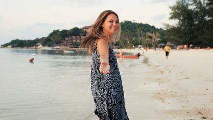 Follow me shot of young pretty woman on tropical exotic beach. Summer vacation or holiday.