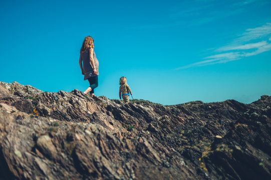 Young mother and her preschooler walking on rocks