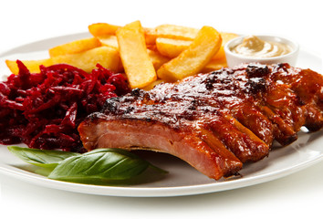 Barbecue pork ribs and vegetables on white background
