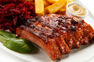 Barbecue pork ribs and vegetables on white background
