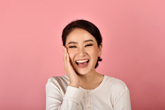 Asian Woman Laughing And Enjoy On Pink Background, Portrait Of Happy Smiling Middle Age Woman In Casual Clothes Looking At The Camera.