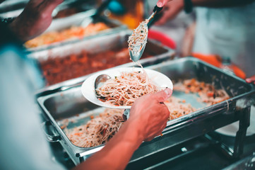 Poor people receive donated food from donors: The hands of the poor receive food from the hands of...