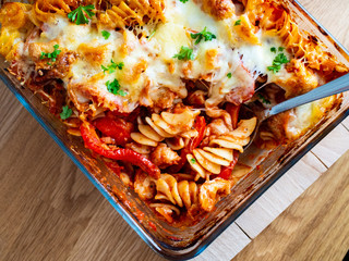 Pasta casserole with barbecue chicken breast, cheese and vegetables
