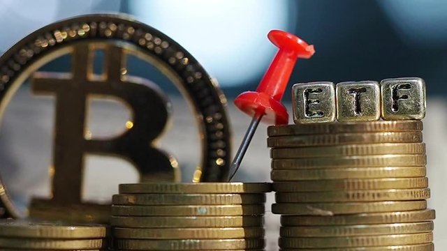 Bitcoin coin and a pile of gold coins  and red pin with ETF text , Concept Entering the Digital Money Fund.