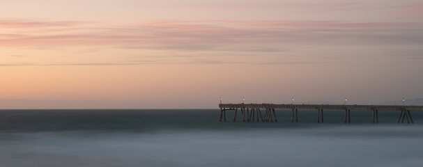 Fototapeta na wymiar Long exposure of the pier under the late evening sky