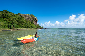 Local people swim in the ocean in a picturesque lagoon on the island of Mauritius