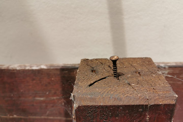 Old rusty nail on the old wood with copy space on the left side.  Selective focus.