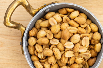 Morning aperitif at the bar. Salted peanuts served on a metal bowl on a June morning.