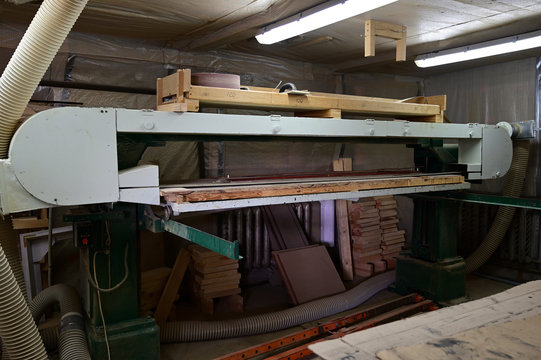 A photo of a woodworking machine in a workshop. Universal industrial concept.