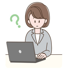 パソコンの前で考えるスーツの女性