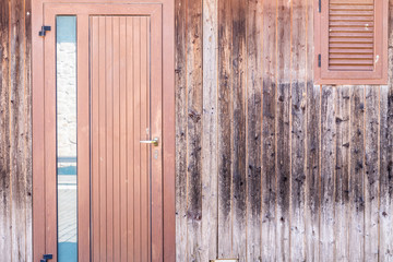 A Sunday in June on a farm in Puglia, a region of southern Italy. A wooden warehouse with a closed door for the collection of some local products.