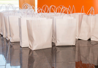eco white paper packages folded in a row on the floor, food for delivery