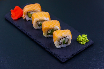 Sushi rolls Philadelphia on a black slate