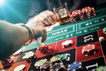 Fototapeta na wymiar Man gambling at the roulette table at the Casino