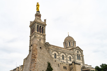 The basilica of Notre Dame de la Garde in Marseille, built in Neo-Byzantine style, At top of the bell tower there is s a golden statue of the Madonna and Child