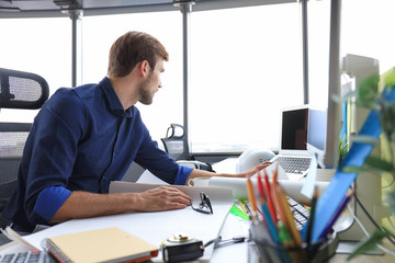 Shot of a handsome male architect working on a design in his office.