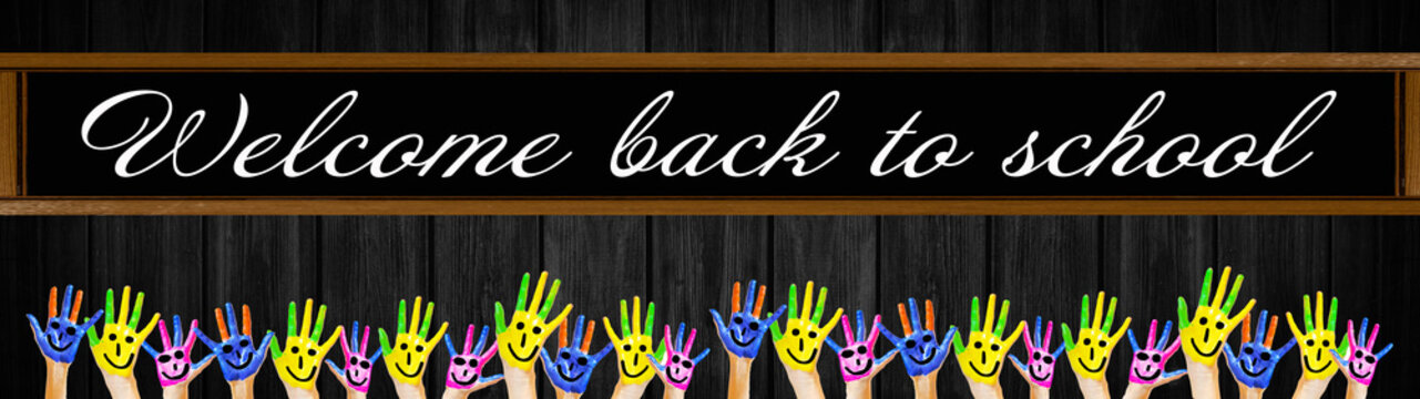 









School background banner panorama - School board with lettering "welcome back to school" and many brightly painted waving children's hands, isolated on black rustic wooden wall texture