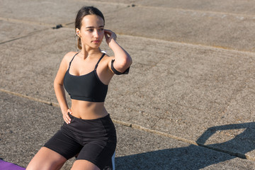 A young slim athletic girl in sportswear with snakeskin prints performs a set of exercises. Fitness...