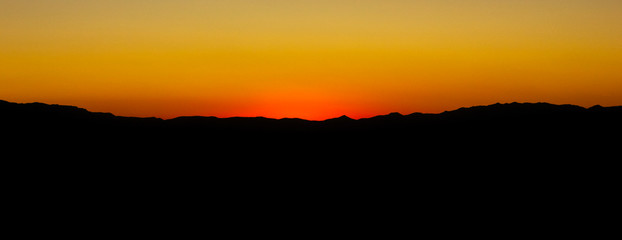 Horizon line on hilly terrain after sunset. Evening sky in the last rays. Abstract night horizon...