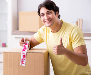 Man moving house and relocating with fragile items