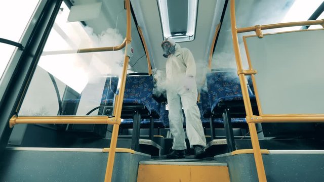 One man sanitizes a bus during pandemic.