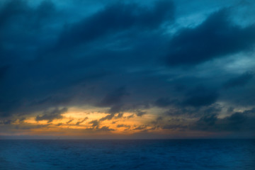 Naklejka na ściany i meble Photo of sunset clouds over ocean 