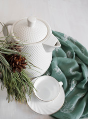 white teapot with tea pair on the table