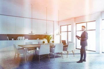 Man in suit in white home library