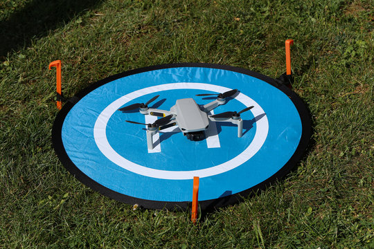 Drone stands on a take-off and landing pad