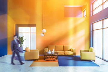 Man walking in blue and orange living room