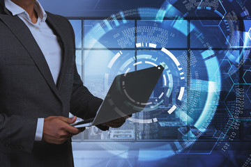 Man with laptop in office, HUD interface