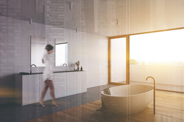 Woman walking in panoramic white bathroom corner