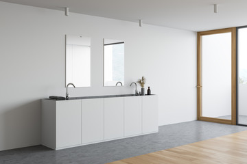 Double sink in minimalistic white bathroom corner