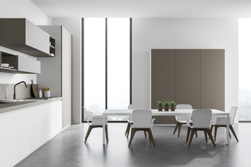 White and beige kitchen with table, side view