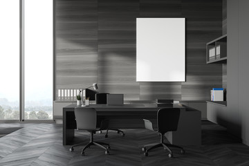 Gray and wood CEO office with poster