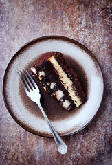 Piece of Chocolate Cake on a Plate. Rustic stone background. Top view