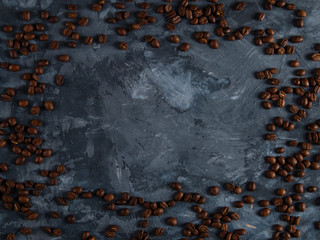 Coffee crumbled on a dark concrete background. Copy space.