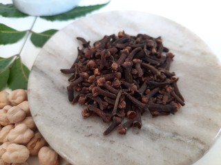 Neem leaves in Mortar Grinder drug and ingredient herbs on plain white background