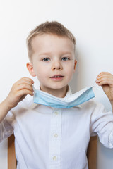 Cute boy in a medical mask. Quarantined children due to an epidemic.