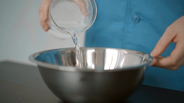 man fills the mold with liquid_slow mo