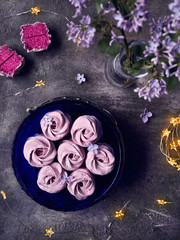 Violet sweet Zephyr Marshmallow near lilac flowers and stars lights