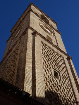 Mudejar bell tower with sebka decoration. Church of Santiago. 16 century. Old city center of Malaga. Spain.   